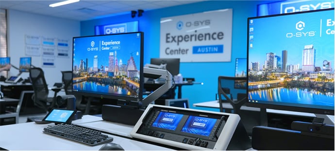 View of an Austin Experience Center desk with Q-SYS peripherals