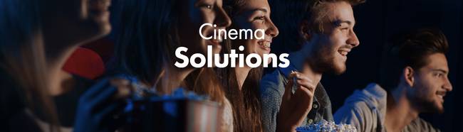 People enjoying popcorn and watching a moving. Text reads: 'Cinema Solutions'